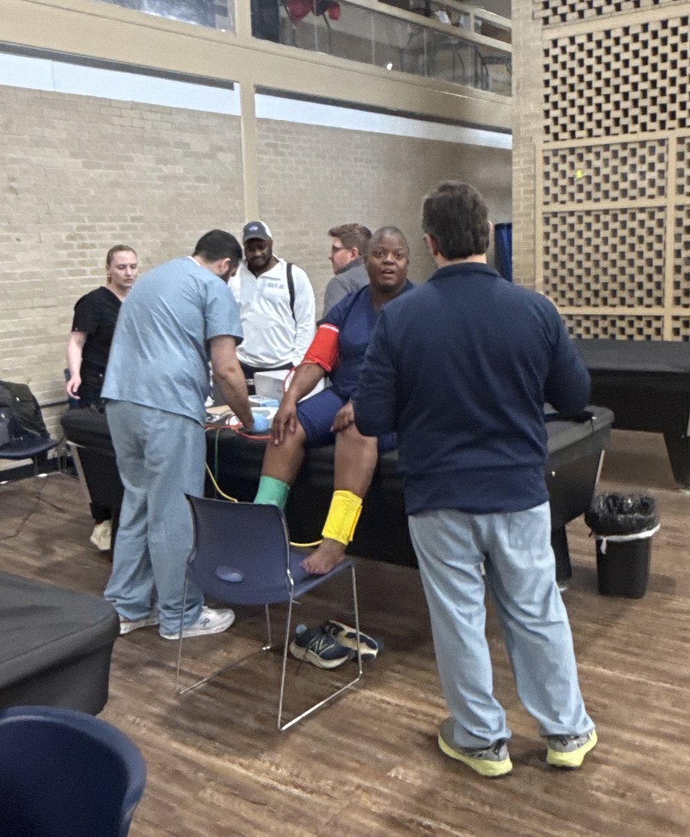 Clinicians checking an attendee's leg at a SALSAL screening