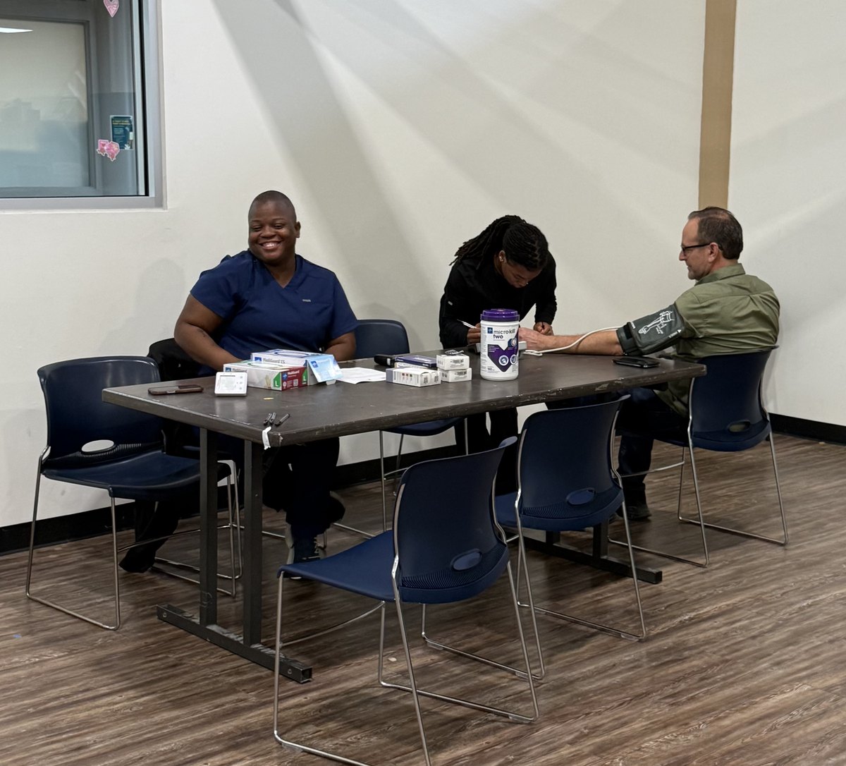 A volunteer clinician at a SALSAL community screening table