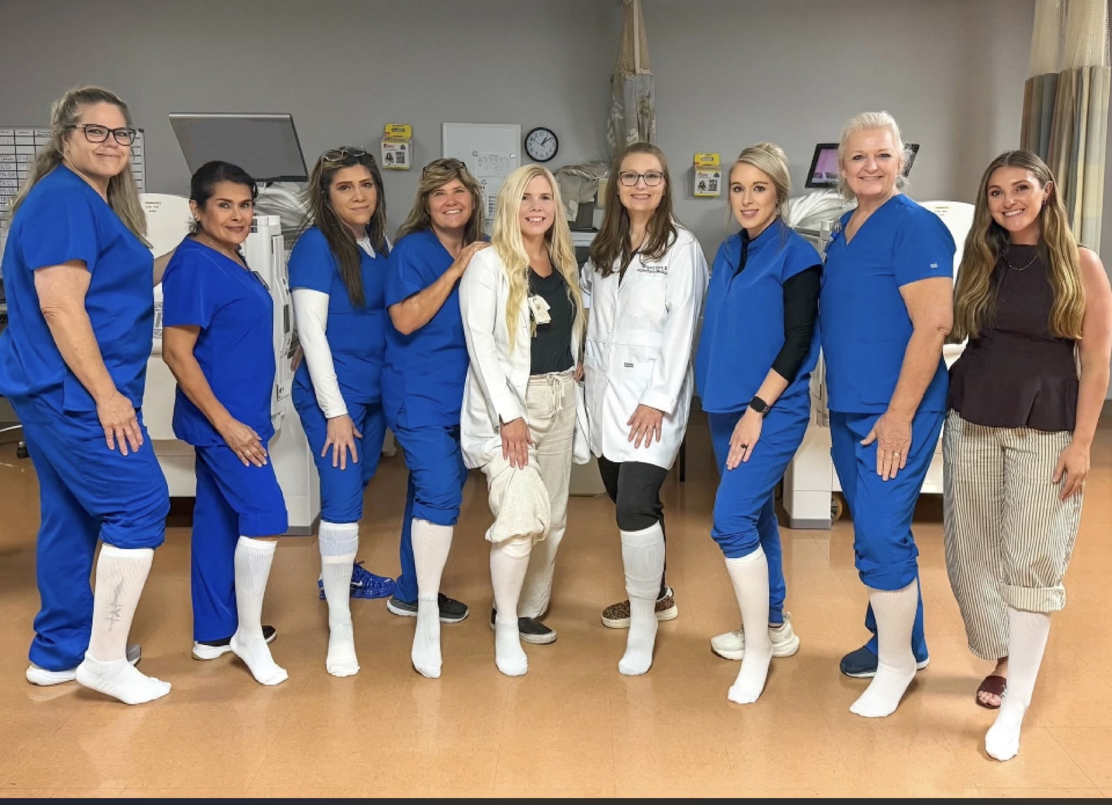A hospital care team, each wearing a single white sock, for the White Sock Campaign